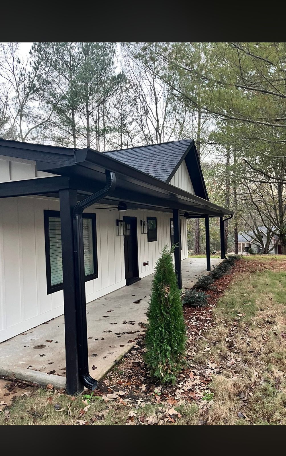 Matte black seamless gutters and downspout installed by H4