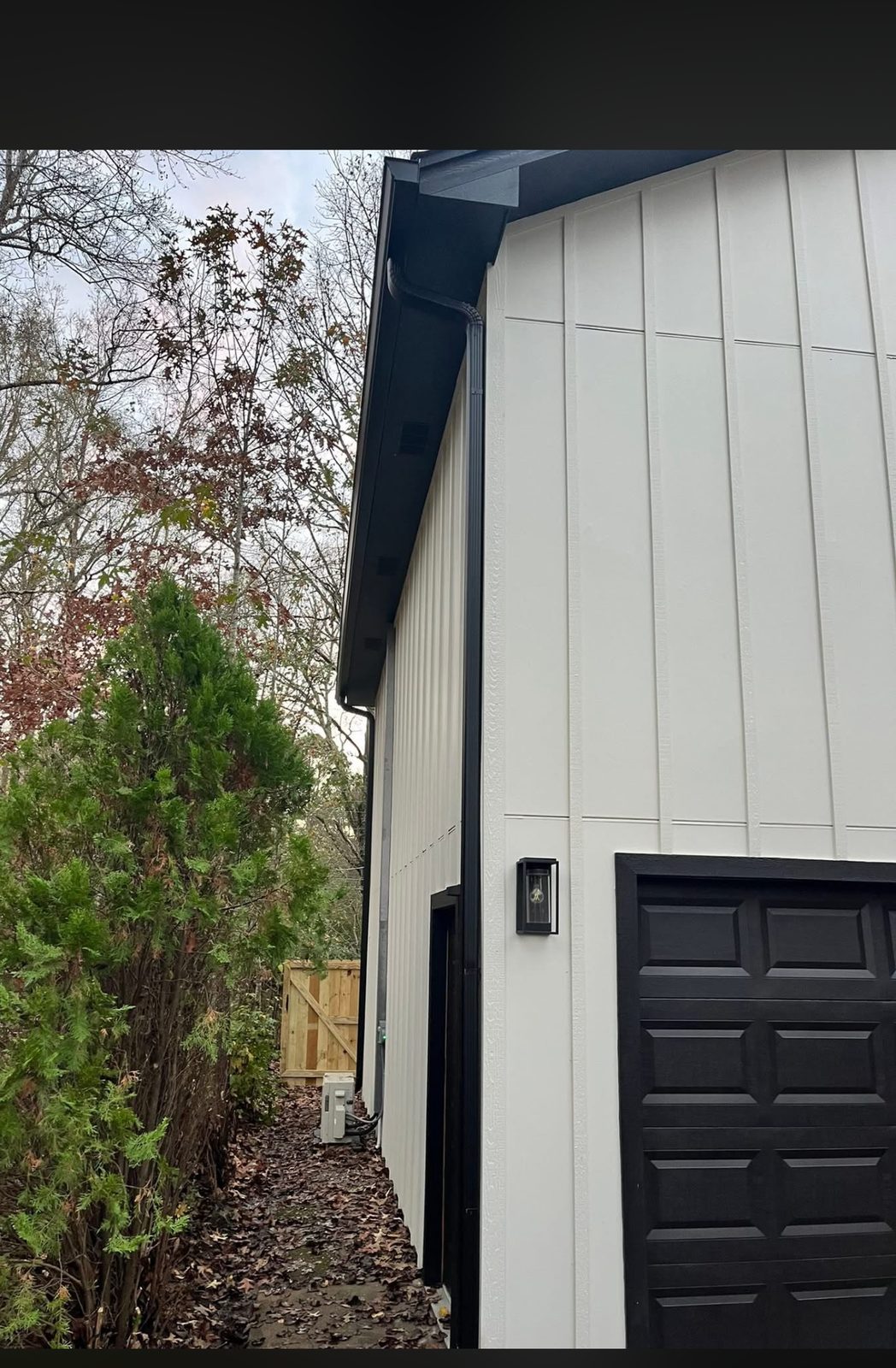 Matte black downspout running a clean corner line