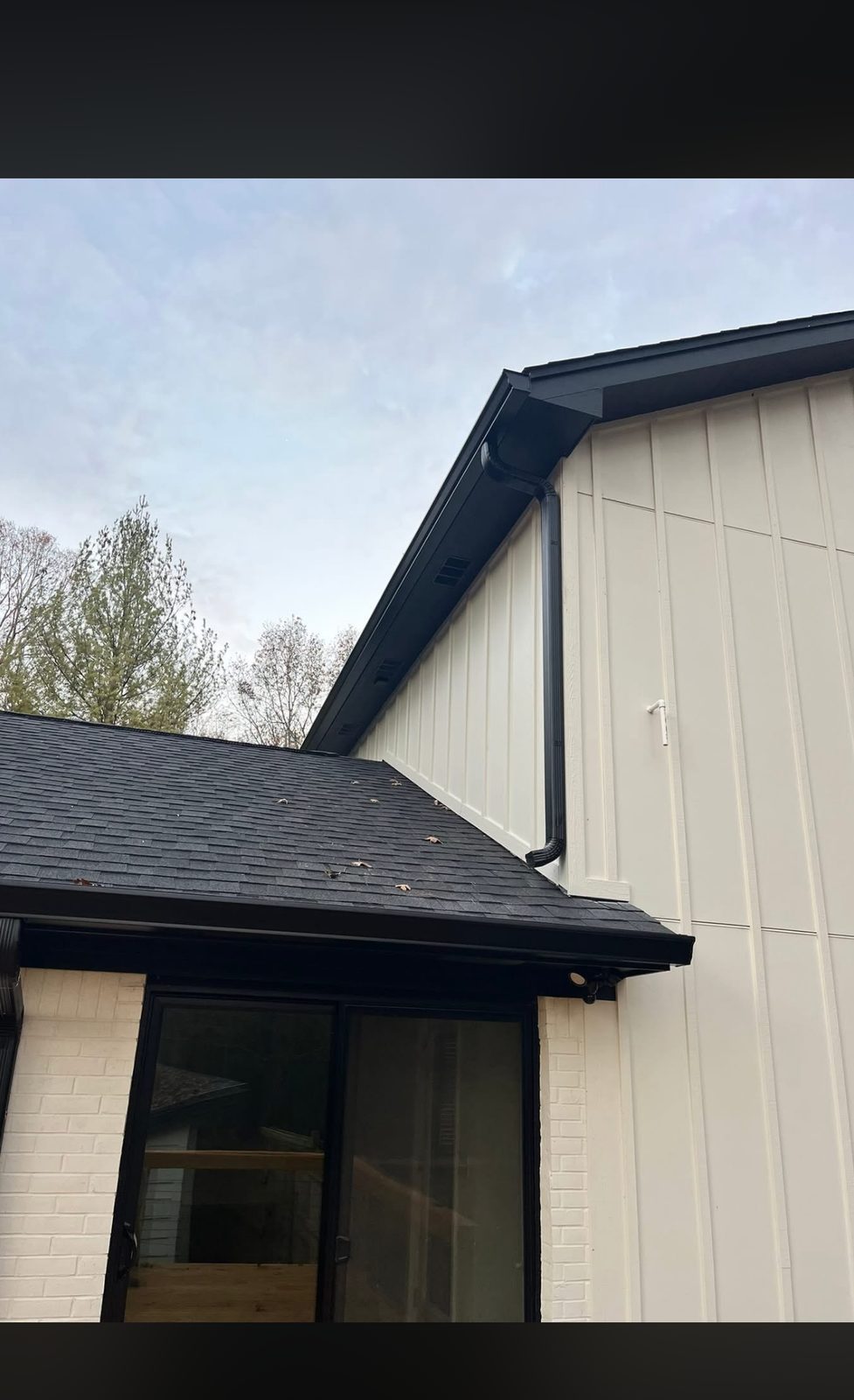 Downspout elbow detail, tucked tight to the roofline